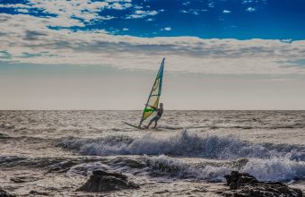 Man windsurfing in sea, Jericoacoara National Park, Ceara, Brazil